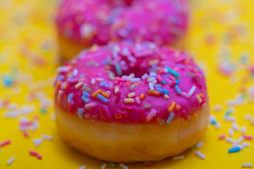 pink donuts with colorful sugar sprinkles 