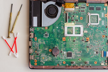Broken laptop on white table. Tools for repair laptops