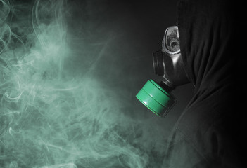 Man in a gas mask in the smoke