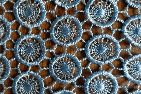 Backdrop - light blue crochet lacy fabric on wood from above