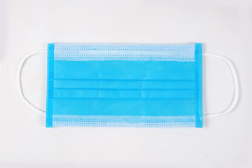 Blue mask and corona virus protection on a white background