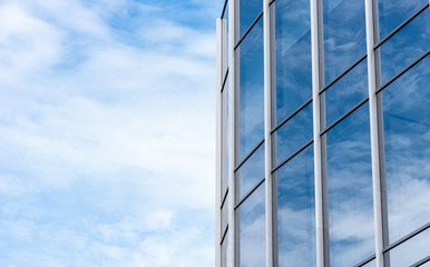 Modern building facade against blue sky with copy space, modern architecture with glass and...