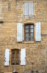 Old  stone house with  wooden shutters in Domme. Perigord, France