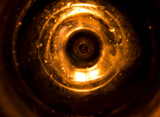 Close up and blurry circle glass with candle light as a background.