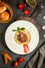 spaghetti with meat sauce sprinkled with grated parmesan