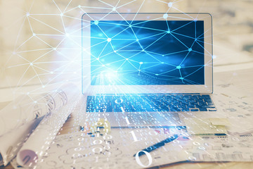 Double exposure of desktop computer and technology theme hologram. Concept of software development.