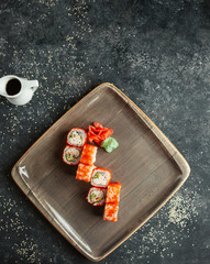 sushi rolls served with ginger and wasabi _