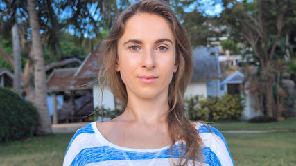 Outdoor portrait of a real 30 years woman looking in camera