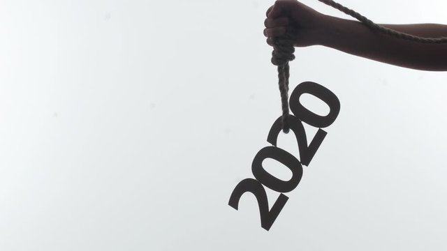silhouette of a male hand with a rope loop with numbers on a white isolated background, concept financial collaps, economic crisis in 2020 year