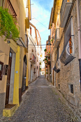 A narrow street between the colorful houses of Capriati al Volturno, a village in the province of Caserta, Italy