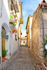 A narrow street between the colorful houses of Capriati al Volturno, a village in the province of Caserta, Italy
