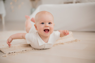 healthy baby is lying on the floor of the house. eco-friendly materials for the home.