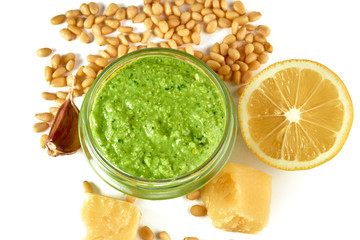 Pesto sauce with ingredients on white background