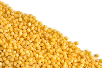 Heap of millet grains isolated on white background