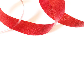 Red ribbon, spiral coil On white paper background with copy space..
