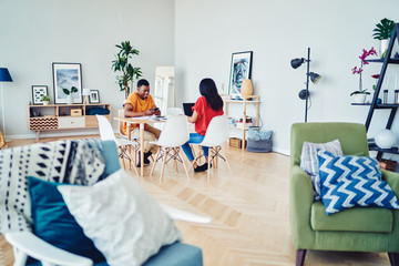 Young couple using gadgets at home