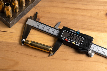 Production of cartridges for a rifle, reload. Measurement of the empty cartridges with a caliper. Top view