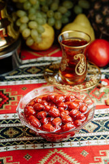 Jam of berries and ripe fruit. Restaurant dish with vegetable decor on a wooden background. Jam in a glass saucer.