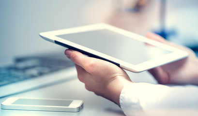 Work online - Remote work from a home office - Woman uses a computer, tablet and smartphone - Popular work model in recent times