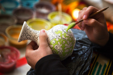 The artist paints a ceramic vase. Uzbekistan