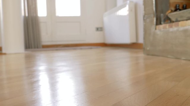 detail of a man's brown and blue shoes dressed in white pants