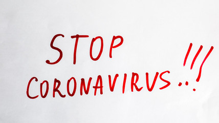 New Coronavirus - 2019-nKoV. Stop Coronavirus inscription with red marker on a white sheet. The concept of quarantine coronavirus in the world.