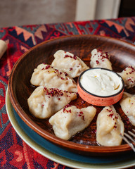 close up of gurza dumplings filled with meat topped with sumac