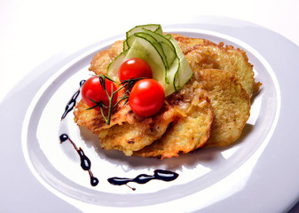 pancakes made from potatoes on a white plate