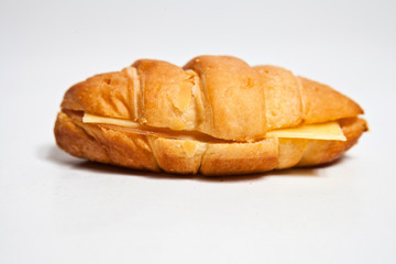 fresh baked croissant with cheese and salami