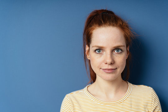 Pretty young redhead woman with large blue eyes