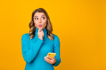 Photo of attractive wavy lady blogger hold telephone write new youth theme post look up empty space...