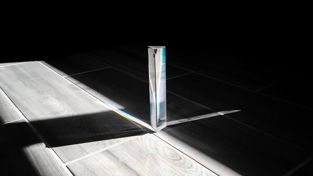 Timelapse of sunlight passing through prism creating rainbow, Concept