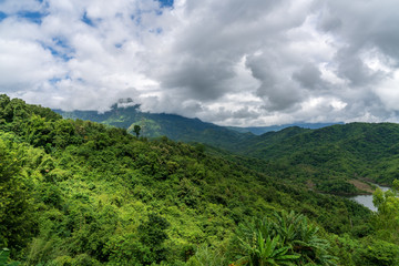 Obraz premium beautiful blue sky high peak mountains mist fog wildlife green forest at Khao Koh, Phu Tub Berk, Phetchabun, Thailand guiding idea long weekend for backpacker camping campfire relaxing hiking