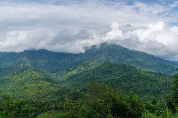beautiful blue sky high peak mountains mist fog wildlife green forest at Khao Koh, Phu Tub Berk, Phetchabun, Thailand 
guiding idea long weekend for backpacker camping campfire relaxing hiking
