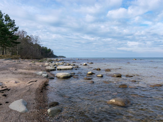 blue seascape with many stones on a sunny day