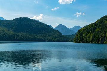 View of the Alpsee lake and the German Alps in the background in a beautiful picture. Photograph taken in Schwangau, Bavaria, Germany.