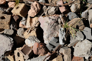 Rubble bricks atop grass in yard