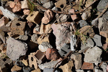 Rubble bricks atop grass in yard