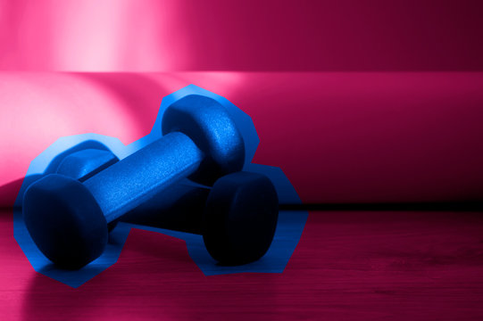 Healthy background fitness equipment, Dumbbell on wooden floor. Healthy lifestyle, sport concept. Pink and pink frame color filter