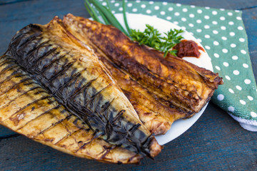 Baked mackerel fish on a white plate