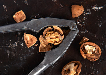 walnuts and nutcracker on a dark background