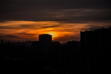 Fototapeta na wymiar evening sunset over high-rise buildings