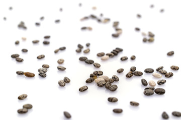 Healthy grains organic Chia Seeds background. Pile nutrition food isolated on white. dieting and detoxication concept with mineral nutrients. Macro close-up shot.