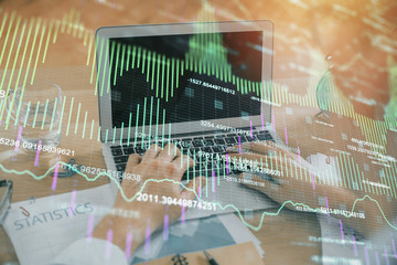 Multi exposure of market chart with man working on computer on background. Concept of financial analysis.