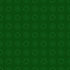 Seamless vector pattern with green clover leaves, shamrock and Horseshoe on a dark green backdrop for St. Patrick's Day. Spring fest background for greetings card, decor, flyer, print, packaging etc.