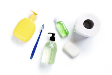 Toiletries set, basic items, essential goods. Liquid soap, toothbrush, hydroalcoholic sanitizer gel and toilet paper roll
