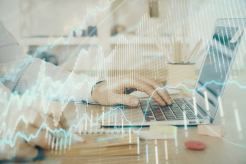 Multi exposure of stock market graph with man working on laptop on background. Concept of financial analysis.