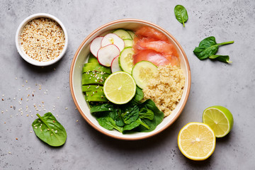 Poke bowl with salmon, spinach, quinoa, cucumber and radish.  Clean Eating Concept
