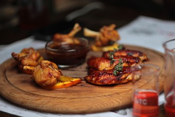 delicious chicken wings on a wooden tray