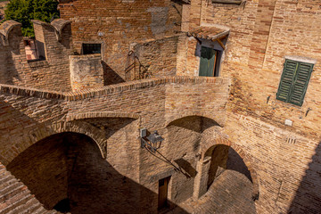 The medieval arches and stairways of Corinaldo city walls, Le Marche, Italy, near Senigallia - obrazy, fototapety, plakaty